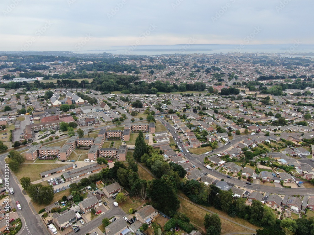 aerial view of housing estate with modern houses and flats looking towards Poole Harbour in the background