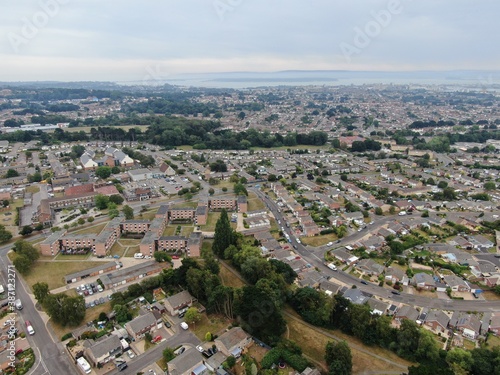 aerial view of housing estate with modern houses and flats looking towards Poole Harbour in the background