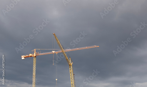 Industrial construction cranes the construction of an building. © Liudmyla