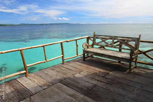 Wooden chair on the dock at Ora Beach Resort in Seram Island, Central Maluku, Indonesia