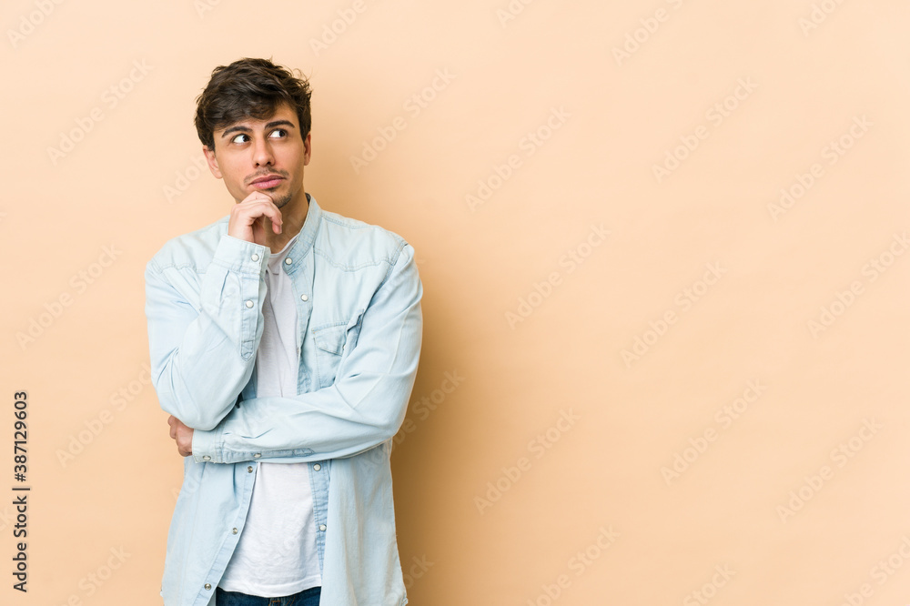 Young cool man looking sideways with doubtful and skeptical expression. Young cool man looking sideways with doubtful and skeptical expression.