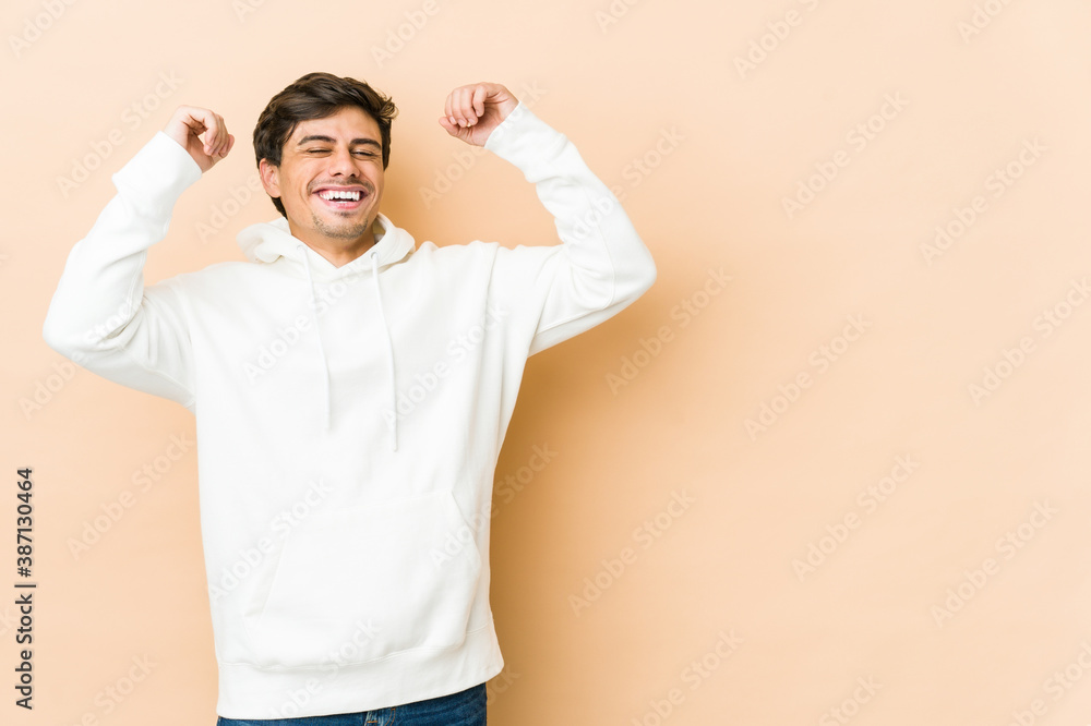 Young cool man celebrating a special day, jumps and raise arms with energy. Young cool man celebrating a special day, jumps and raise arms with energy.