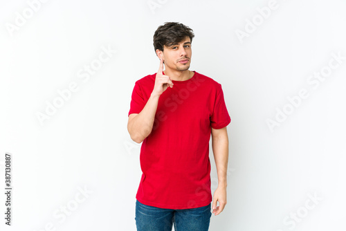 Young cool man showing number one with finger.