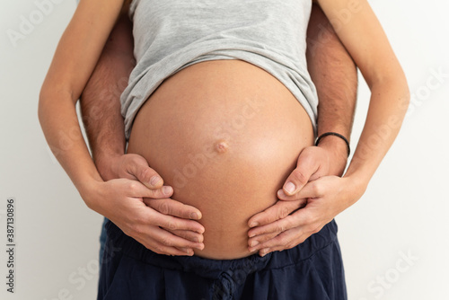 New parents expecting a baby and embracing the pregnant belly.