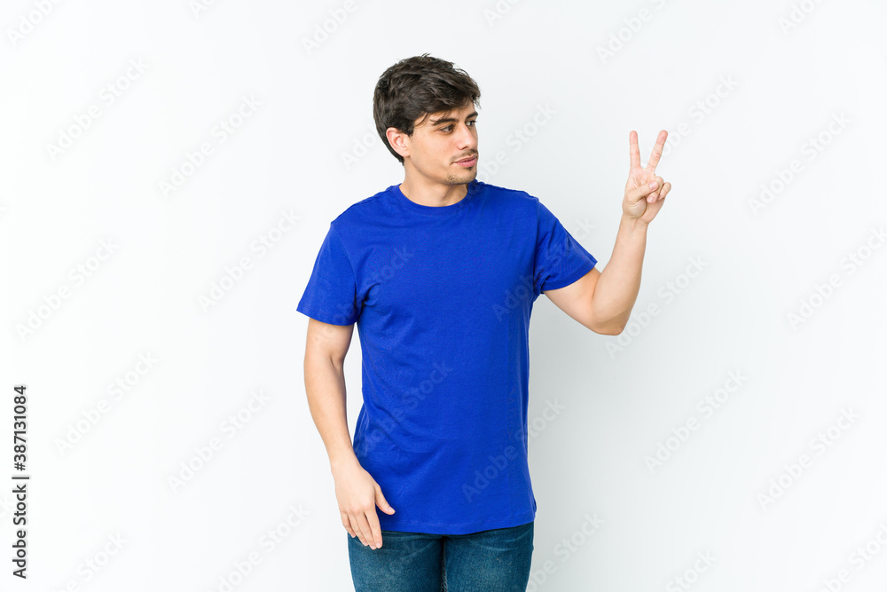 Young cool man joyful and carefree showing a peace symbol with fingers. Young cool man joyful and carefree showing a peace symbol with fingers.