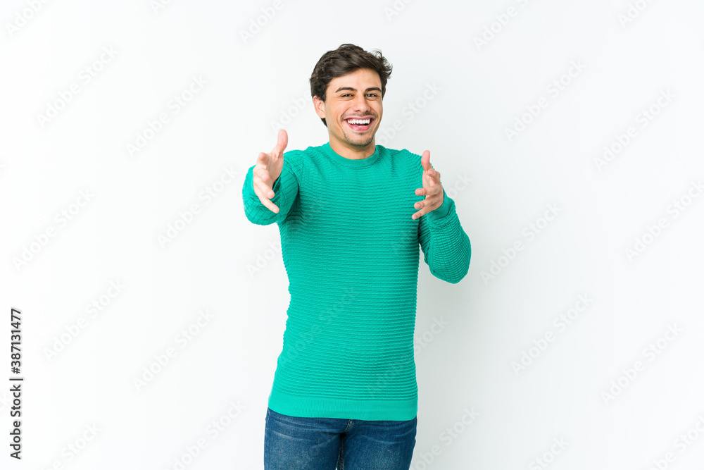 Young cool man feels confident giving a hug to the camera. Young cool man feels confident giving a hug to the camera.