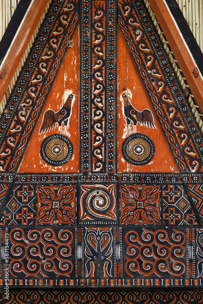 Vertical close-up view of the colorful gable’s ornaments of a tongkonan, traditional ancestral house, Tana Toraja, Sulawesi, Indonesia Vertical close-up view of the colorful gable’s ornaments of a tongkonan, traditional ancestral house, Tana Toraja, Sulawesi, Indonesia