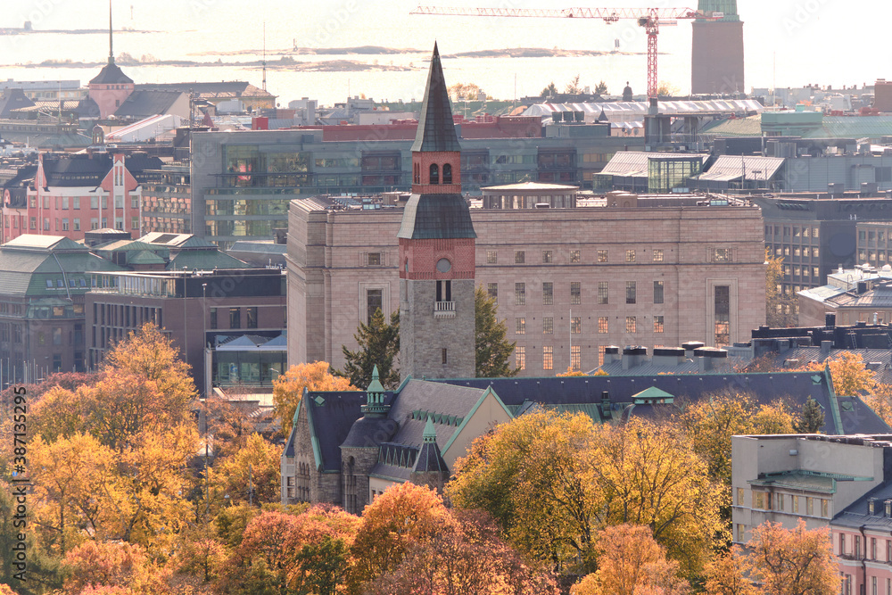 The National Museum of Finland among the yellow trees in autumn. View of the center of Helsinki, Finland.