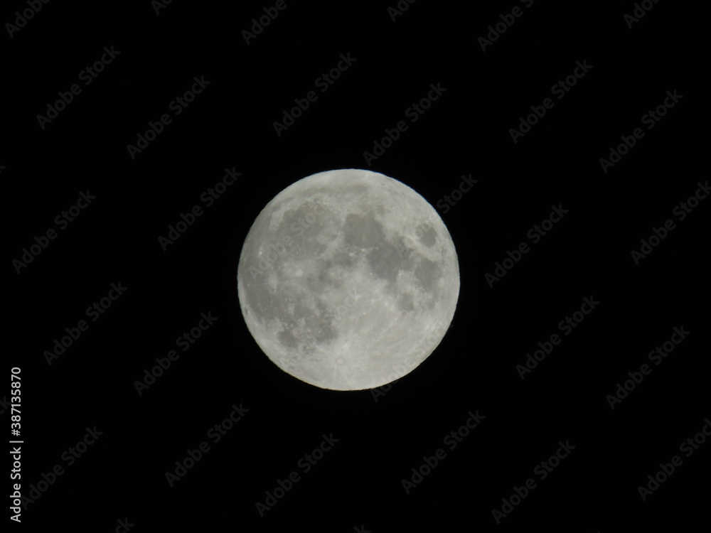 Genova, Italy - 09/25/2020: An amazing photography of the full moon over the city of Genova by night with a great clear sky in background and some stars Genova, Italy - 09/25/2020: An amazing photography of the full moon over the city of Genova by night with a great clear sky in background and some stars