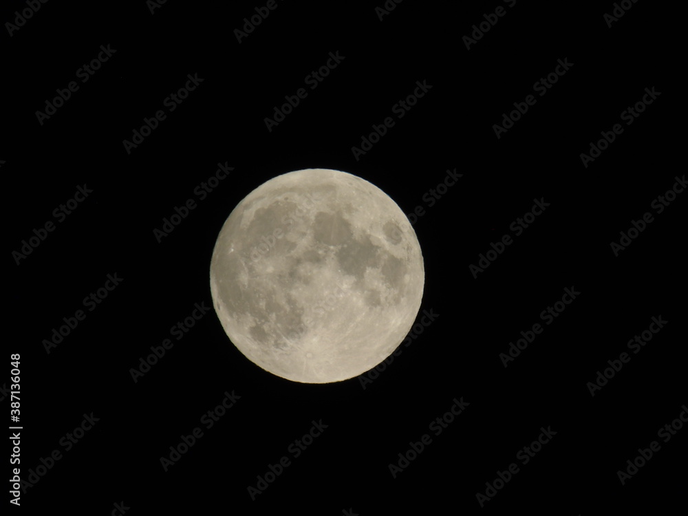 Genova, Italy - 09/25/2020: An amazing photography of the full moon over the city of Genova by night with a great clear sky in background and some stars Genova, Italy - 09/25/2020: An amazing photography of the full moon over the city of Genova by night with a great clear sky in background and some stars