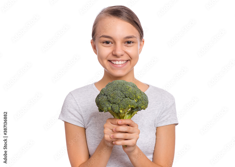 Happy beautiful young teen girl holding perfect product for dieting green broccoli, isolated on white background Happy beautiful young teen girl holding perfect product for dieting green broccoli, isolated on white background