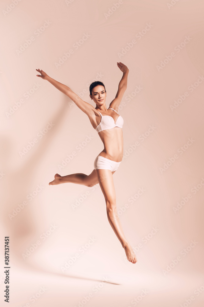 sepia jumping woman in underwear