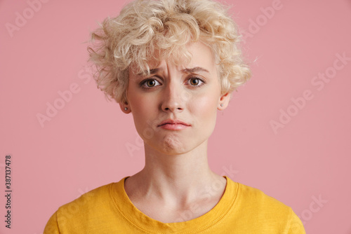 Portrait of a young blonde girl with curly blonde hair