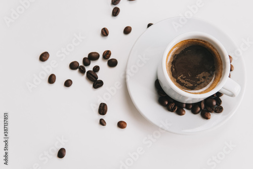 Coffee cup and coffee beans on a white background.