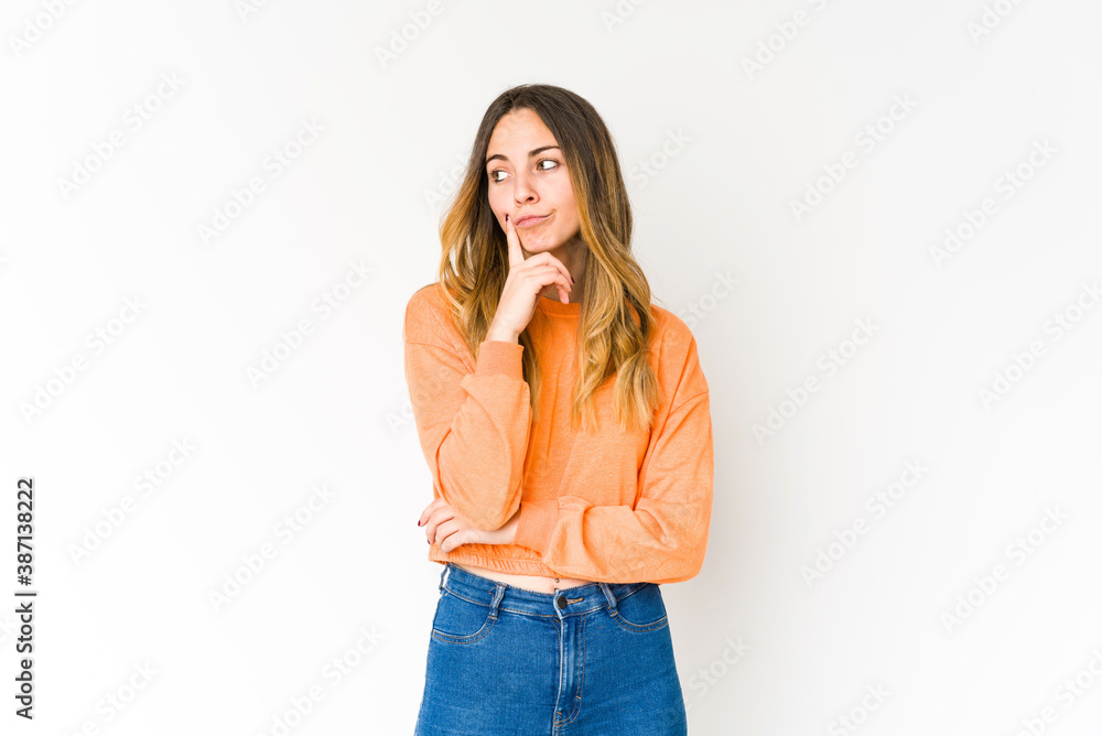 Young caucasian woman isolated on white background looking sideways with doubtful and skeptical expression. Young caucasian woman isolated on white background looking sideways with doubtful and skeptical expression.