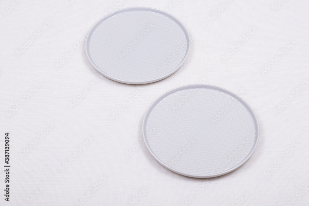Two empty plates on a light tablecloth. Two empty plates on a light tablecloth.