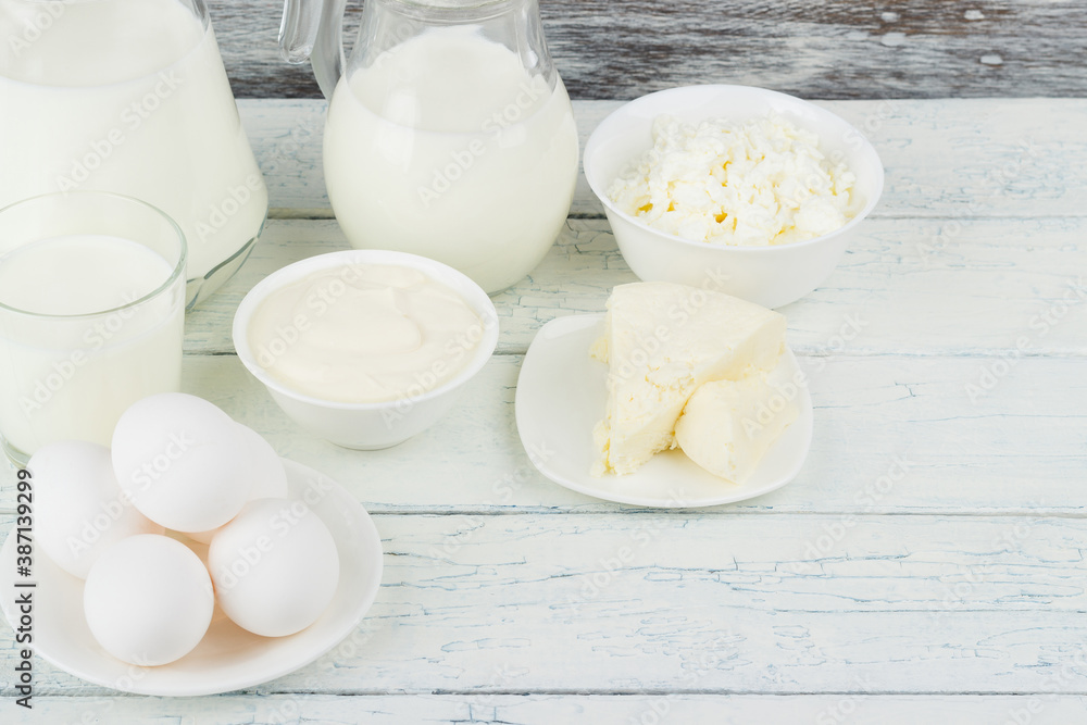 Different dairy products on the white wooden boards Different dairy products on the white wooden boards