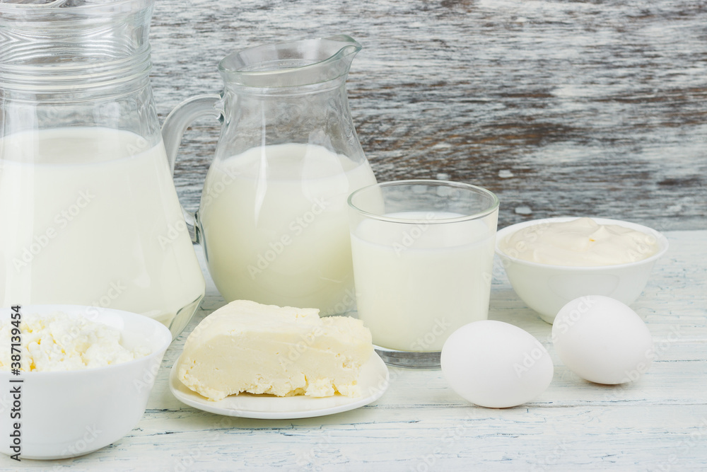 Different dairy products on the white wooden boards Different dairy products on the white wooden boards