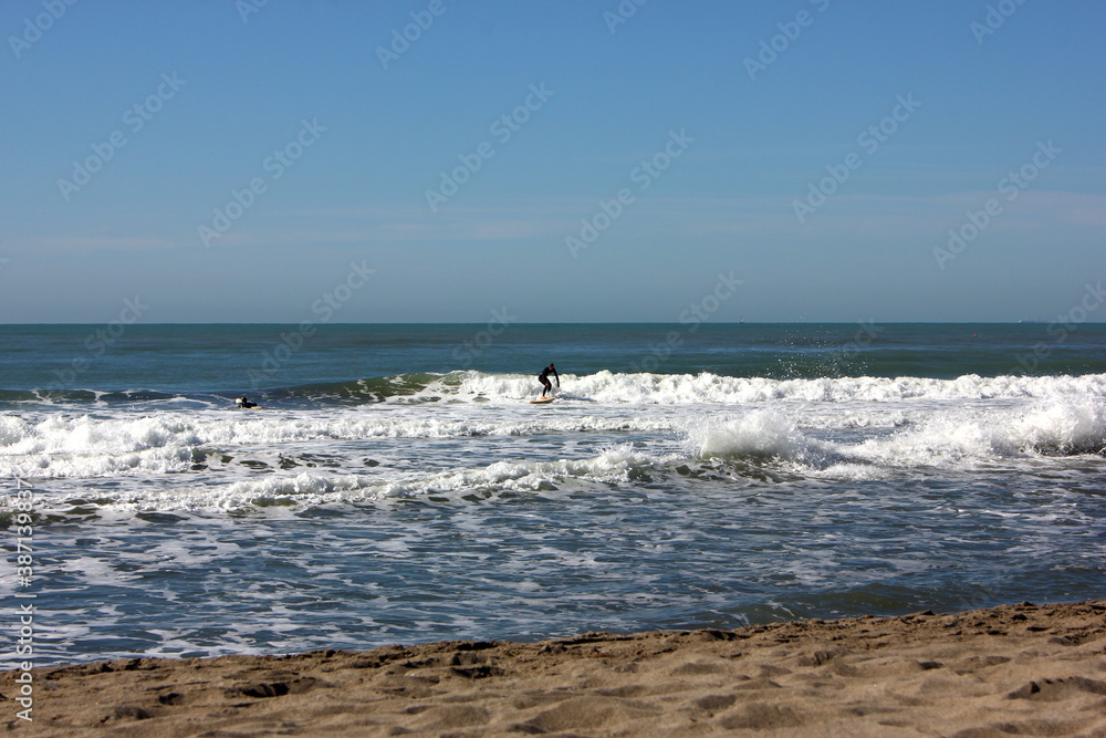 Surfing in corona times at Forte dei Marmi, Tuscany, Italy