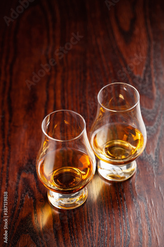glass of whisky spirit brandy on dark brown background