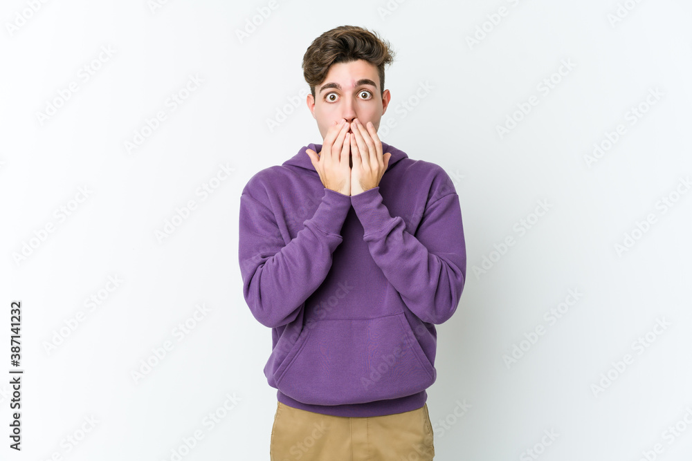 Young caucasian man isolated on white background shocked covering mouth with hands. Young caucasian man isolated on white background shocked covering mouth with hands.