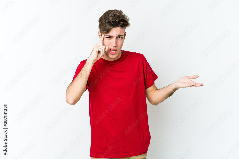 Young caucasian man isolated on white background showing a disappointment gesture with forefinger. Young caucasian man isolated on white background showing a disappointment gesture with forefinger.