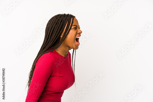 Young african american woman isolated shouting towards a copy space