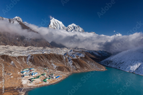 Gokyo lake and the village on the coast. Beautiful high himalayas landscape. Nepal. photo