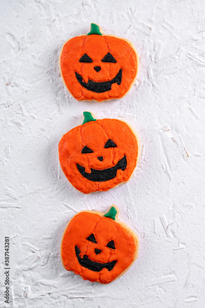 Top view of Halloween festive decorated icing sugar cookies on white background. Top view of Halloween festive decorated icing sugar cookies on white background.
