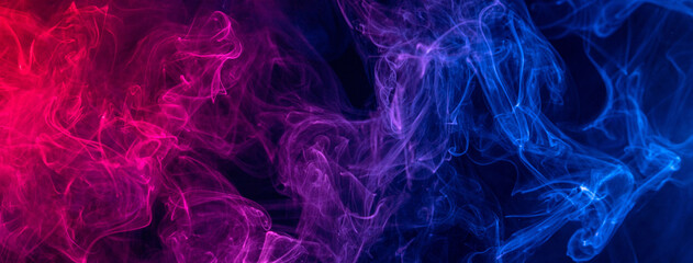 Conceptual image of colorful red and blue color smoke on dark black background.