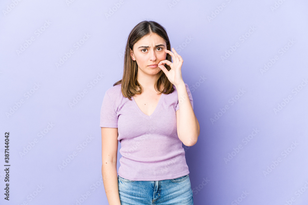 Young caucasian woman with fingers on lips keeping a secret. Young caucasian woman with fingers on lips keeping a secret.