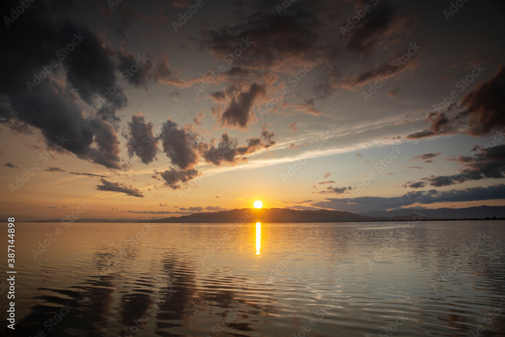 A sunset over water with clouds