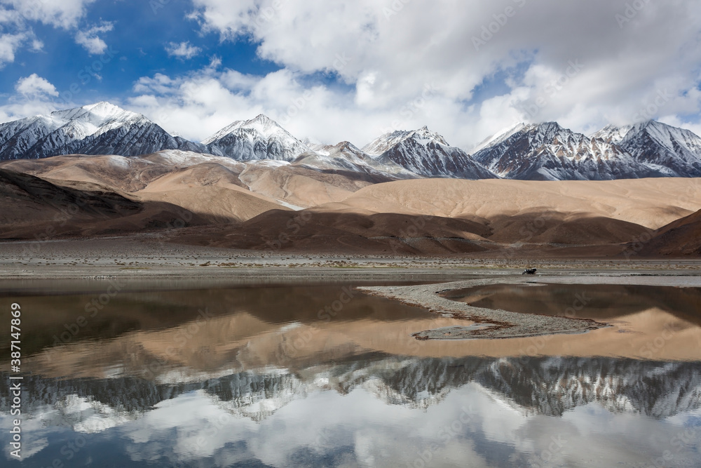 Beautiful landscape at Pangong lake, Ladakh. High altitude lake and snowy himalayan peaks. Moto travel in India.