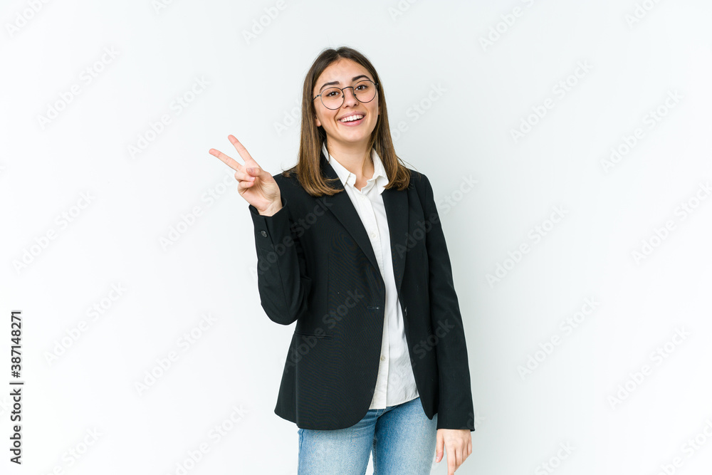 Young caucasian business woman joyful and carefree showing a peace symbol with fingers. Young caucasian business woman joyful and carefree showing a peace symbol with fingers.