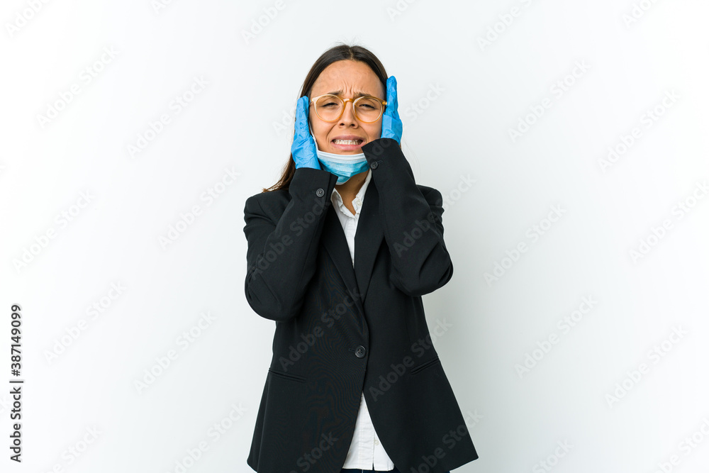 Young business latin woman wearing a mask to protect from covid isolated on white background whining and crying disconsolately. Young business latin woman wearing a mask to protect from covid isolated on white background whining and crying disconsolately.