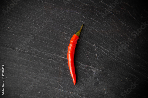 spicy red chili pepper on black slate background