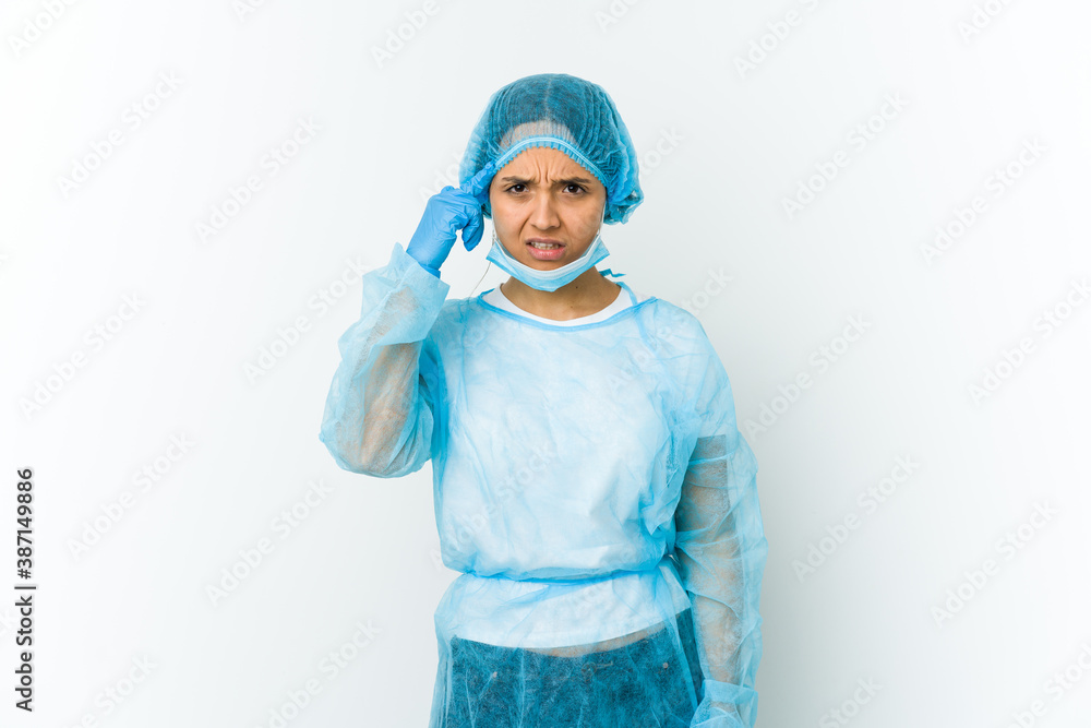 Young surgeon latin woman isolated on white background showing a disappointment gesture with forefinger. Young surgeon latin woman isolated on white background showing a disappointment gesture with forefinger.