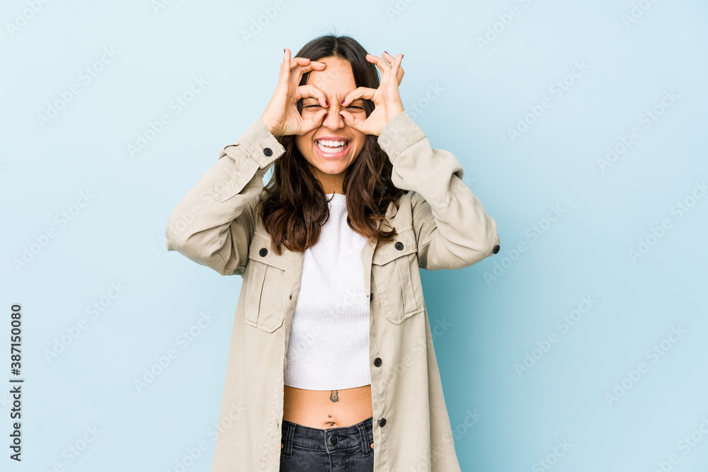Young mixed race hispanic woman isolated excited keeping ok gesture on eye. Young mixed race hispanic woman isolated excited keeping ok gesture on eye.