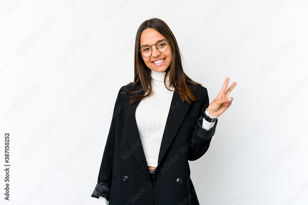 Young mixed race business woman isolated on white background showing victory sign and smiling broadly. Young mixed race business woman isolated on white background showing victory sign and smiling broadly.