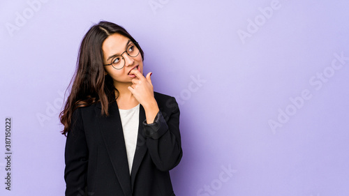 Young mixed race hispanic woman isolated relaxed thinking about something looking at a copy space.