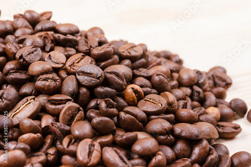 Fresh roasted coffee beans on wooden table. Macro shot.