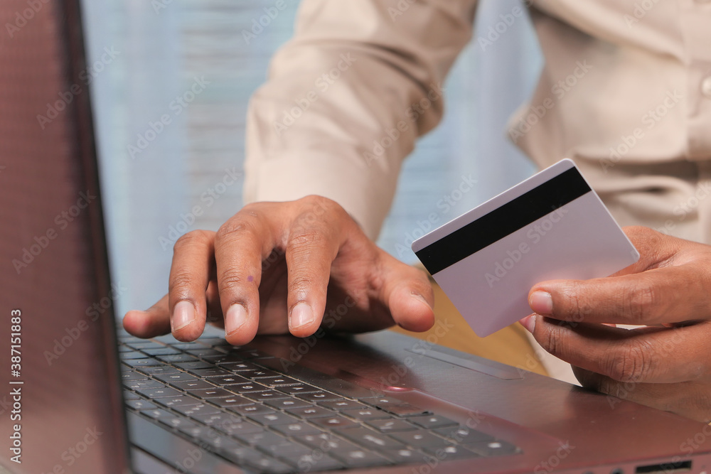 man hands holding credit card and using laptop shopping online man hands holding credit card and using laptop shopping online
