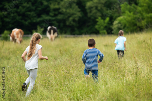 Group of kids running around on a field and having fun together