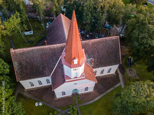 Fotografi Aerial close up on lutheran church tower with red roof, Smiltene, Latvia