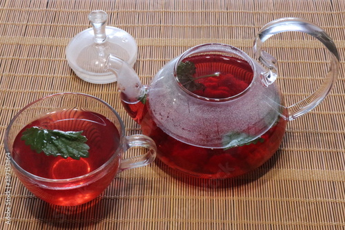 Teapot with red tea with mint