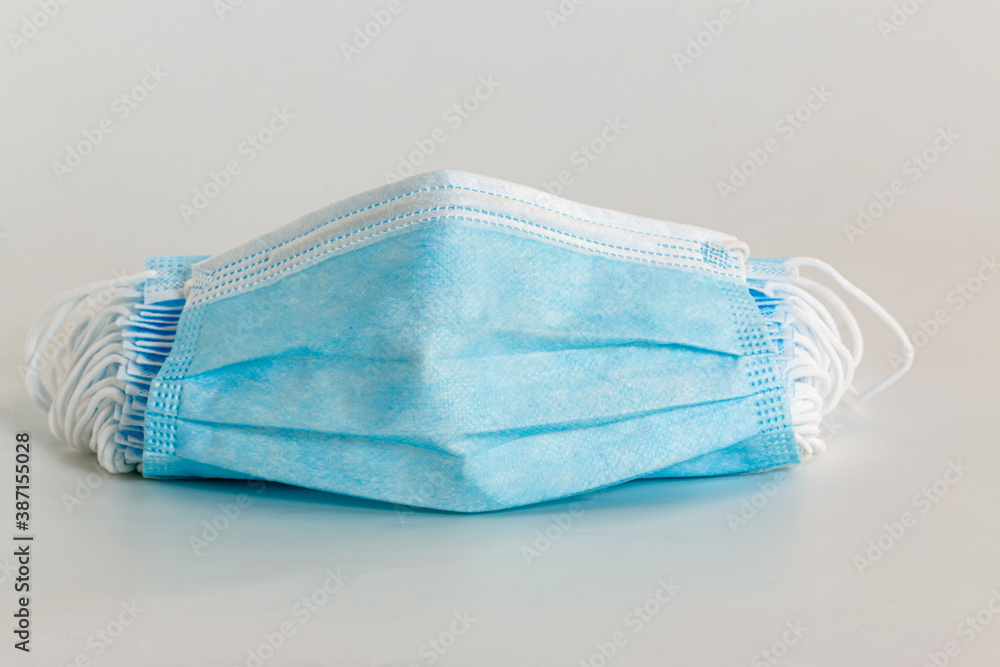 Medical mask on white background, COVID 19 protection ,pollution, virus, Health care concept Medical mask on white background, COVID 19 protection ,pollution, virus, Health care concept