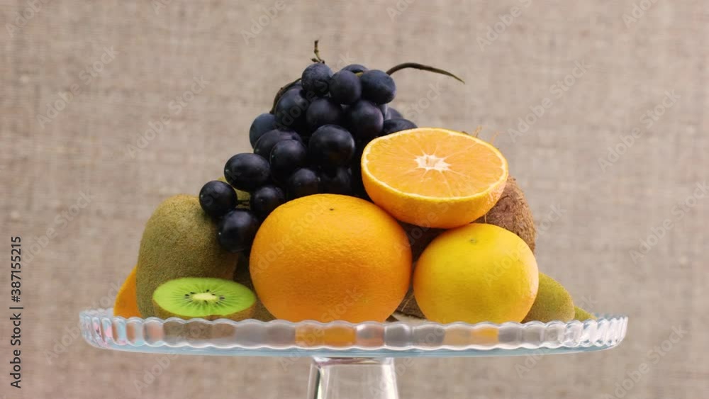 Fast rotating and slow down various kind of fresh ripe fruits on glass crystal bowl Fast rotating and slow down various kind of fresh ripe fruits on glass crystal bowl