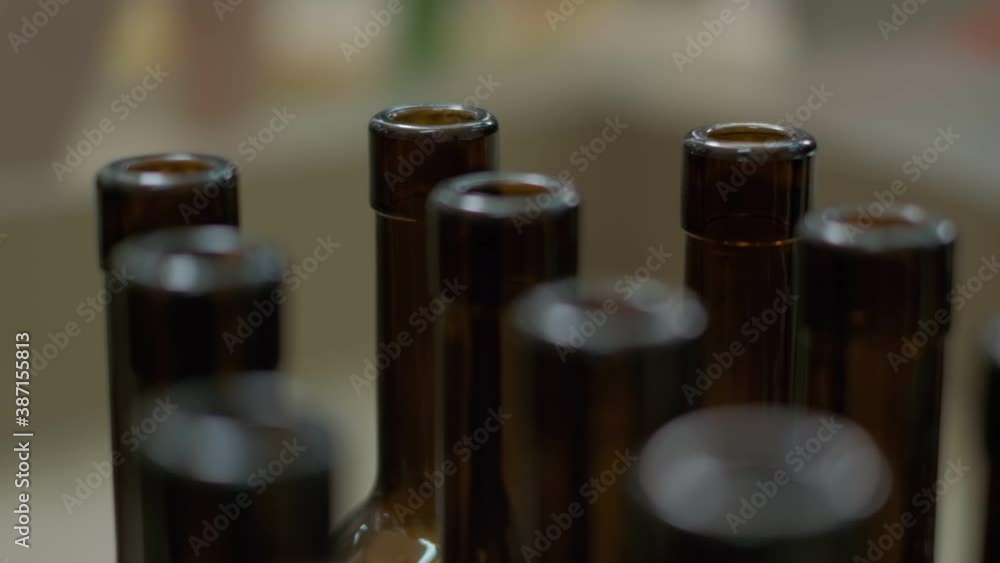 Empty wine bottles made of brown glass being taken off the conveyor. Close up slow motion Empty wine bottles made of brown glass being taken off the conveyor. Close up slow motion