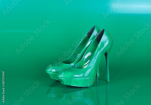 green women's shoes on a green background