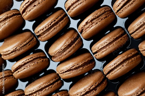 Set of Many tasty macarons Chocolate on bright box background. a pattern of colorful french cookies. homemade food.